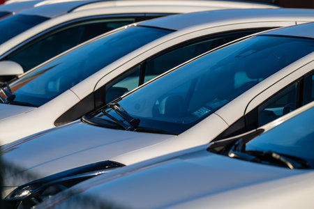 Row of white cars on a parking lot