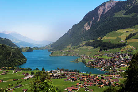 Mountain view with village and blue lakeの写真素材