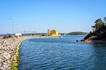 Yellow cable ferry linking the islands to mainland on a beautiful summer day in Parainen, Finland.の写真素材