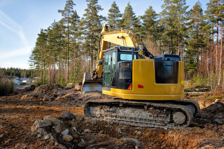 Close-up details of industrial excavator working on road construction.