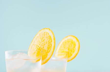 Cold citrus  beverage with orange, alcohol, ice in misted shot glass on green  background, closeup, top, edge, details.の写真素材