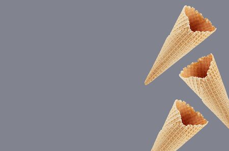 Empty ice cream cones as decorative border on grey green background, mock up for advertising, design, menu.の写真素材