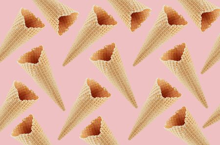 Empty waffle ice cream cones as decorative random summer food pattern on soft light pastel pink...