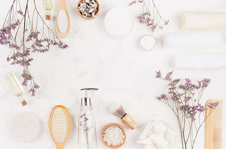 Fresh natural eco accessories and cosmetics for bathroom with elegant lavender twigs and decorations on white background, top view, frame.の写真素材