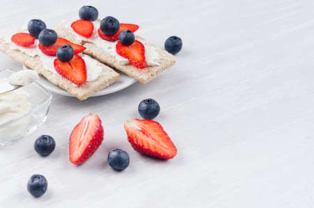 Fresh spring vitamine sandwiches of flat cereal rye dry crisps bread with ripe strawberry slices,...