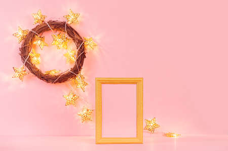 Festive gentle New Year background with glitter glossy gold glowing stars lights in wreath and empty...