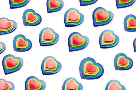 Bright rainbow hearts isolated on white, pattern, top view.