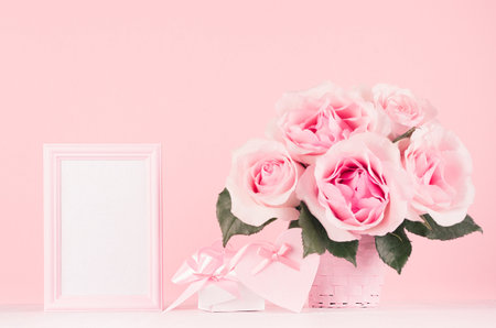 Girlish gentle Valentine days interior - blank frame for text, exquisite pink roses, gift box, heart with ribbon and bow on white wood board, copy space.の写真素材