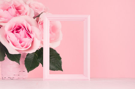 Modern fashion Valentine days background - blank frame for advertising and rich pink roses on white wood board, copy space.の写真素材