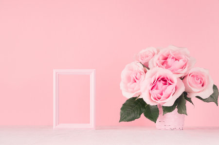 Romance festive interior - delicate pastel pink flowers, blank frame fof design and taxt on white...