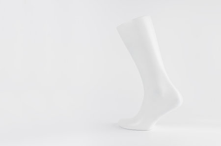 White male mannequin leg side view on white background with copy space, simple modern style layout for presentation, design, advertising.の写真素材