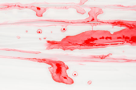 Splashes and stripes of scarlet red liquid paint on white as bright art abstract texture,...
