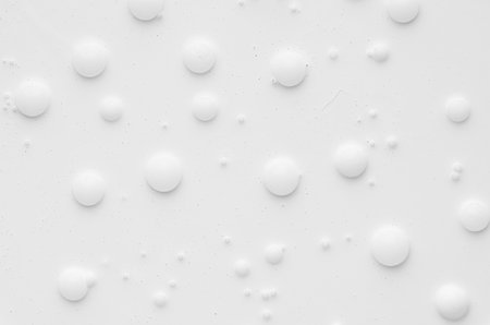 White liquid paint texture with random bubbles and stains as modern abstract background.の写真素材