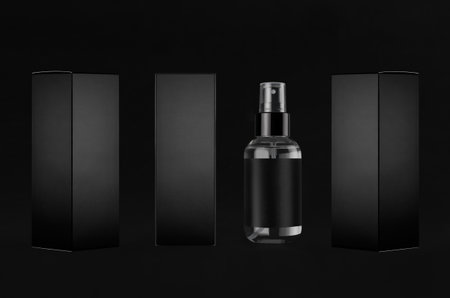 Luxury black mock up for design of packing cosmetics product - small transparent spray bottles, label, paper boxes sides, dark backdrop.の写真素材