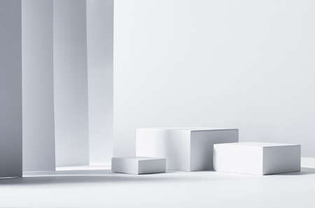 Minimalist abstract design for presentation and product display - white square podiums in sunlight with shadow in white geometric interior.の写真素材
