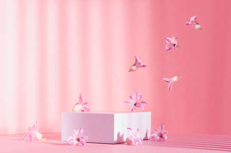 Romantic elegance three white square podiums with flow of levitate spring flowers in sunlight with...