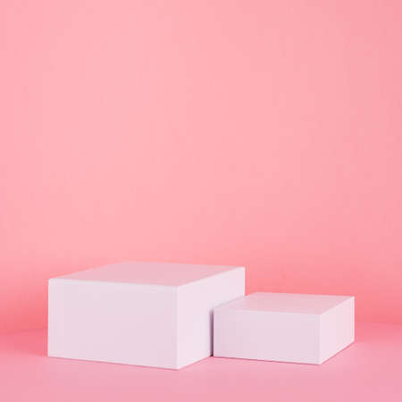 White square podiums for display cosmetic and goods on gentle pastel pink spring background, modern fashion style.の写真素材