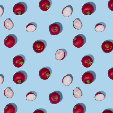 Radish and shadow in hard light on blue background as vegetable seamless pattern.の写真素材