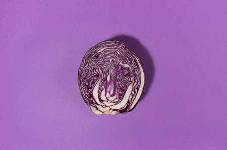 Vegetable colorful abstract background - slice of red cabbage on purple background, copy space, top view.の写真素材