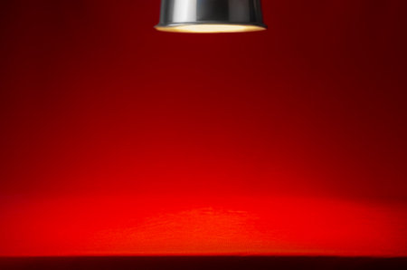 Red scene with spotlight and spot of light and edge of ramp. Abstract classic theater stage background for design, showing, presentation.の写真素材