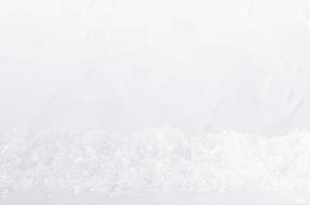 Christmas white frosty shiny bright snowflakes and fake snow as snowdrift with blur as abstract winter background, closeup.の写真素材