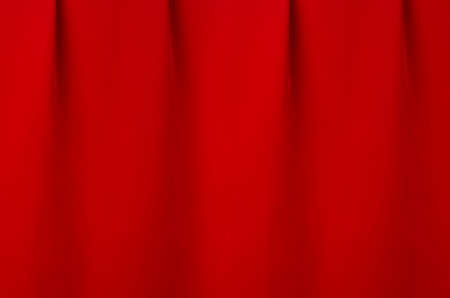 Saturated scarlet red silk curtain with smooth creases as luxury classic theater abstract background.の写真素材