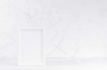Bright frosty winter mockup with white wood blank rectangle photo frame with soft light white branches in hoar, copy space. Festive christmas template for text, message, design, advertising.の写真素材