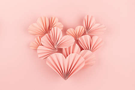 Simple elegant pink paper heart of flying little ribbed hearts on cute pink color - Valentine day...