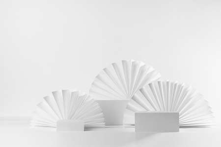 White abstract elegant modern scene with three different size rectangle box podiums mockup for presentation of cosmetic product, advertising, design with oriental folds paper fans in fashion style.の写真素材