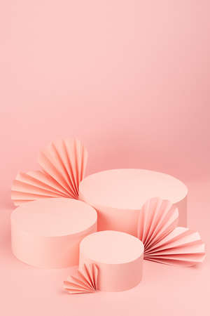 Beautiful pink Valentines day scene mockup with three different size cylinder podiums, paper hearts, copy space, vertical. Love template for presentation cosmetic produce, goods, advertising, design.の写真素材