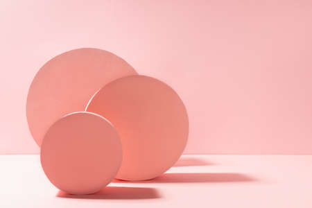 Modern geometric abstract stage mockup with pastel pink round shapes in sunlight with shadows on soft light background, copy space. Abstract scene for presentation products, advertising, design.の写真素材