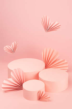 Gentle pastel pink abstract stage mockup with group of three round podiums, fly paper hearts of fans in chinese style, copy space, vertical. Scene template for advertising, presentation cosmetic.の写真素材