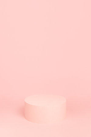 Fashion pastel pink stage with one round podium mockup on soft light background, copy space, vertical. Trendy template showcase for presentation cosmetic product, goods, advertising, design.の写真素材
