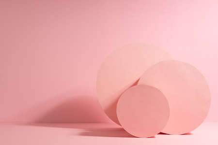 Fashion minimal pink stage in modern simple style with group round box standing as abstract composition in sunlight with shadows, copy space. Scene for presentation products, advertising, design.の写真素材