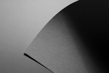Carbon gray abstract geometric background with triangle of textured sheet with shadow as monochrome stylish backdrop for text in elegant simple modern minimal style, top view, copy space.の写真素材