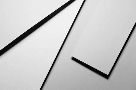 Light gray abstract geometric background with soar rectangle spaces, stripes, lines, corners in hard light with black shadows in simple strict modern style for business card, poster, flyer, top view.の写真素材
