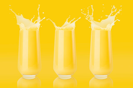 Set of three yellow orange fresh juices in glass with reflection, drops and splashind colorful yellow background. Vitamin organic pulpy citrus summer drink with splashes, drops and motion in glass.の写真素材