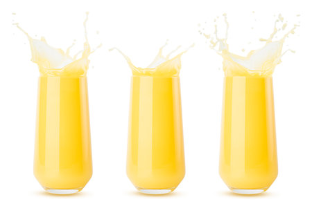 Set of three yellow orange cool juices in glass juicy splashes and drops fly isolated on white background. Ripe summer fruit citrus drink with bubbles, swirl and splashing.の写真素材
