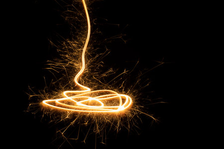 New Year festive abstract background with sparkler line with sparkles as swirl, funnel or spiral on...