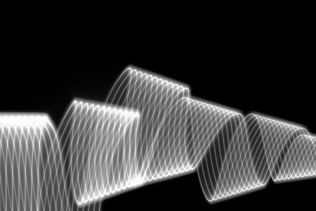 White neon glowing wave of light as curls or spirals with smooth stripes on black background....