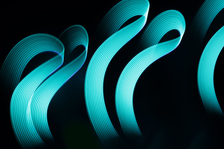 Turquoise blue glowing neon wave of light as curls or swirl with smooth stripes on black background,...