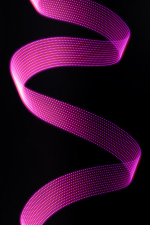 Pink and purple neon glowing wave of light with dotted stripes on black background, vertical. Abstract background with motion light effect, light painting in disco party style.の写真素材