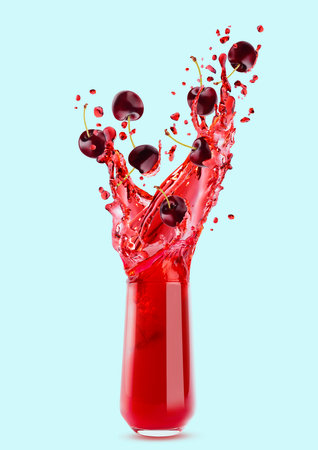 Red cherry juice in drinking glass, flying cherry pieces, drops, splashes on blue background. Summer fruits, beverage for advertising, label product, flyer, card, design.の写真素材