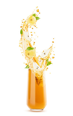 Fresh pear juice in a glass with flying vibrant yellow pear slices, green leaves, streams and splashes of juice. Perfect for healthy drink advertising, design, flyer, card, poster. Isolated on white.の写真素材