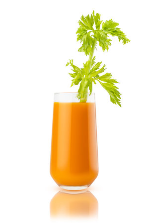 Fresh carrot juice garnished with fresh green celery, in glass, reflection, closeup, isolated on white background. Healthy organic drink for design of detox diet menu, cuisine or restaurant.の写真素材