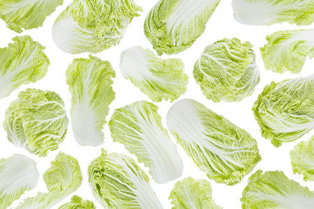 Organic vegetables pattern, texture of crunch raw green chinese cabbage. Whole head and leaves fly or fall, isolated on white background. Ideal for healthy eating and salad menu design.の写真素材