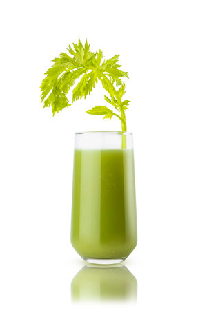 Fresh green vegetable juice of spinach, greens, cucumber with a vibrant celery stalk garnish in glass, isolated. Antioxidant vitamin beverage of organic vegetable for healthy eating menu restaurant.の写真素材