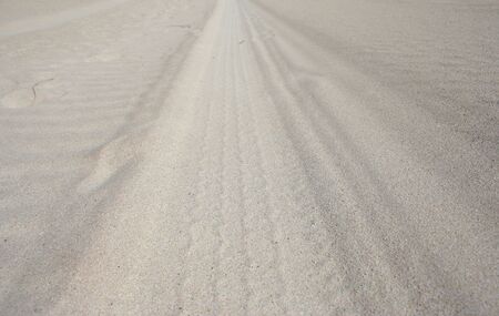 tyre track across sandの写真素材