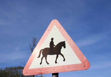 Warning horse riding on road signの写真素材