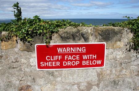 Warning cliff face sudden drop signの写真素材